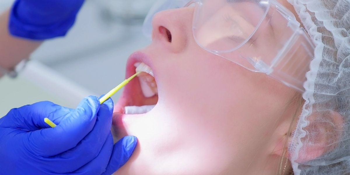 a patient getting fluoride during a dental visit